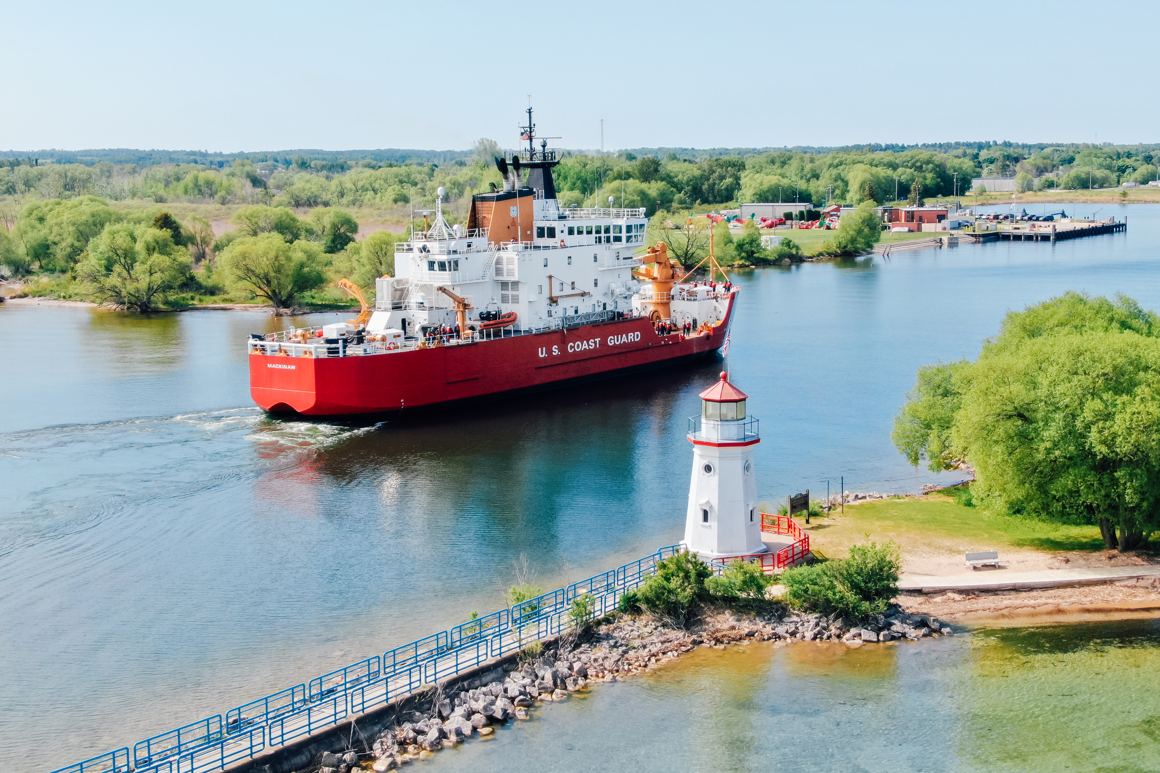 Cheboygan Crib Light A coast guard ship sailing past a lighthouse in a channel