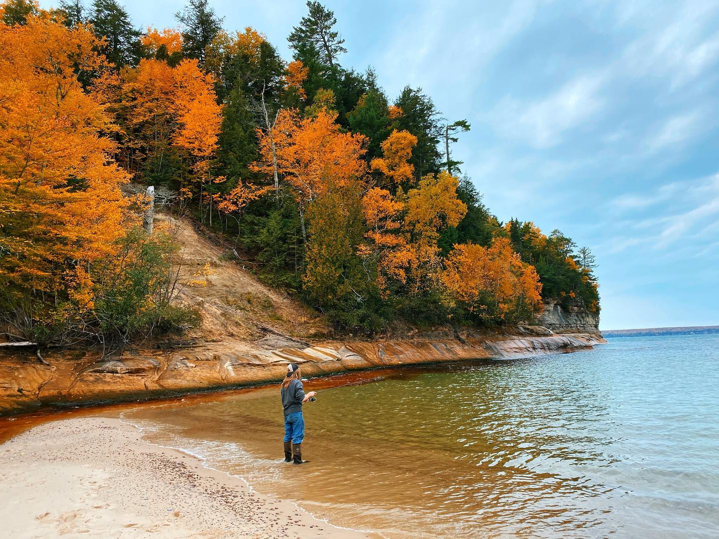 Fishing in at Pictured Rocks National Lakeshore A man fishing on a river mouth on Lake Superior