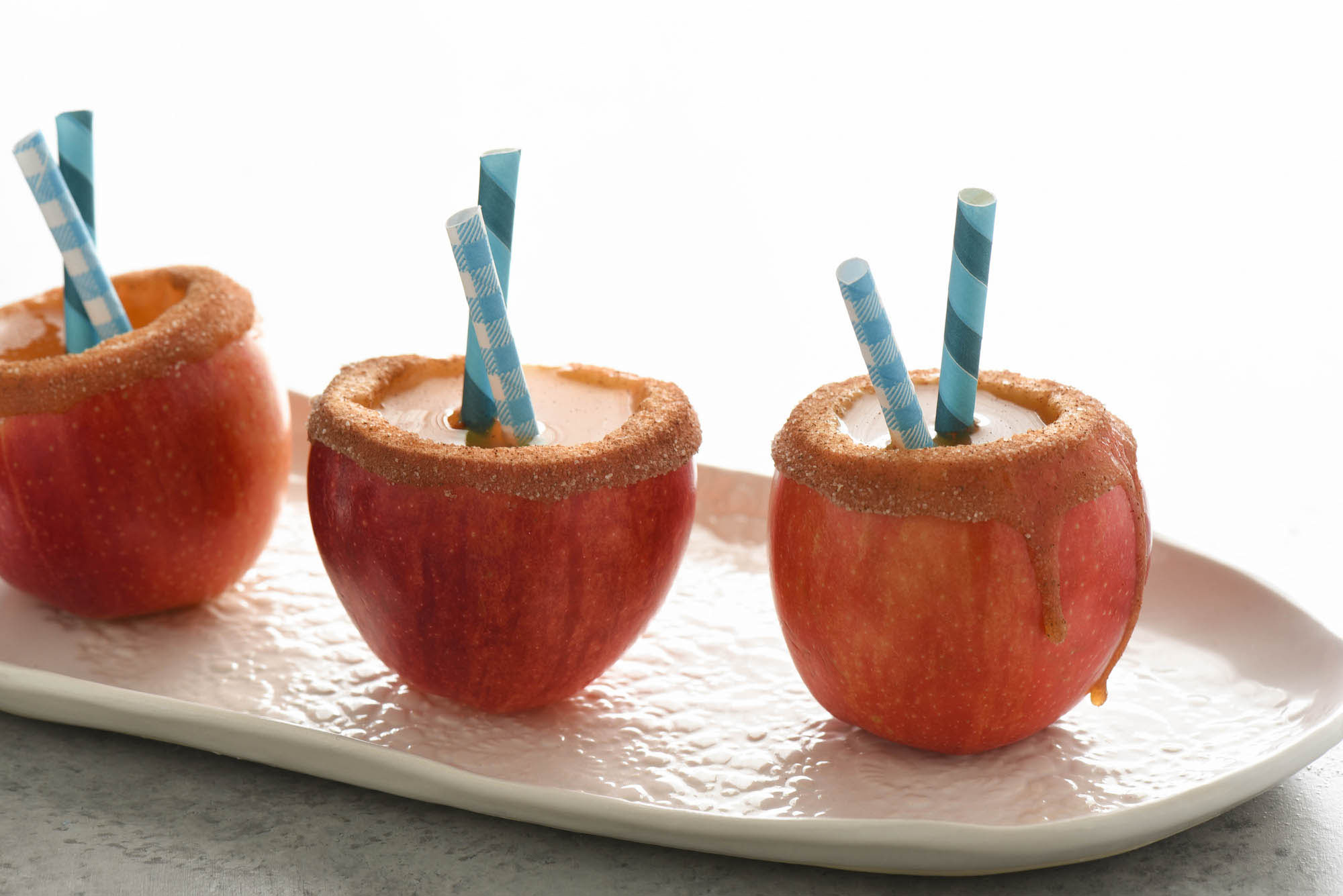 Caramel Apple Rum Punch Cups made with apples filled with a homemade cider drink.