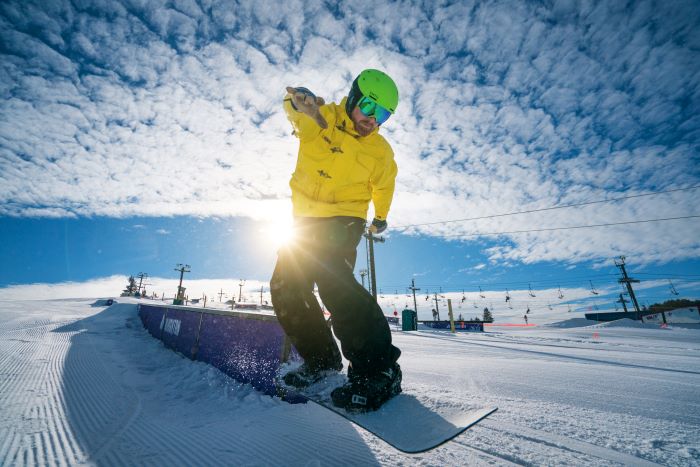 A man snowboarding on Mount Brighton.