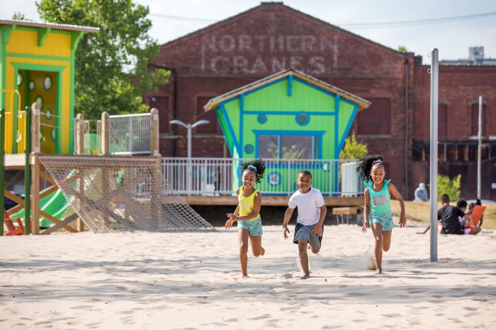 Children running on the beach at Valade Park.